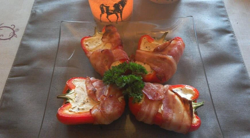 Paprika mit geschmolzenem Käse im Speck