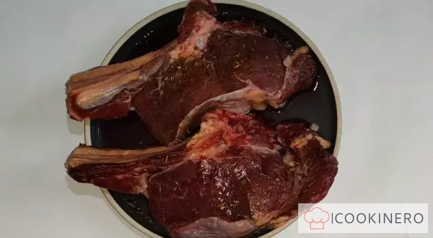 Appetitliches Steak mit Knochen und Champignons in einer cremigen Sauce