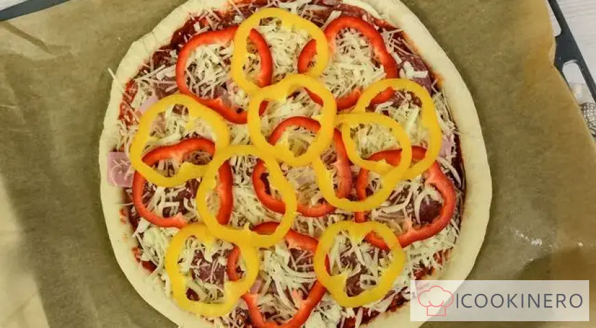 Homemade pizza with ham, smoked sausage and bell pepper