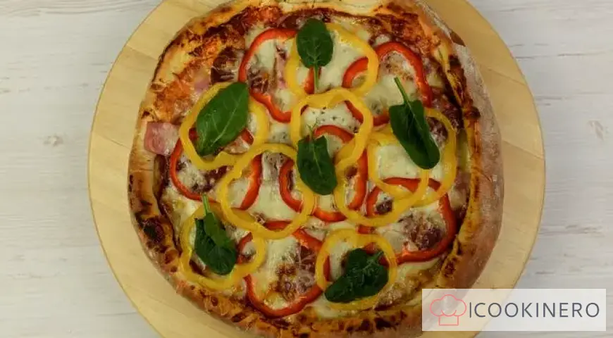 Homemade pizza with ham, smoked sausage and bell pepper