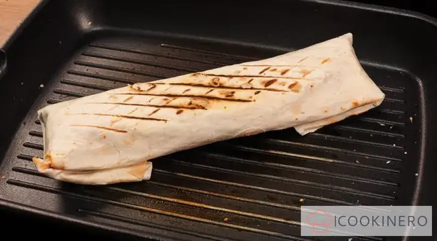 Shawarma from boiled sausage with Chinese cabbage and dried herbs