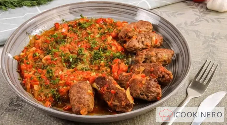 Chevapchichi in bell pepper and tomato sauce