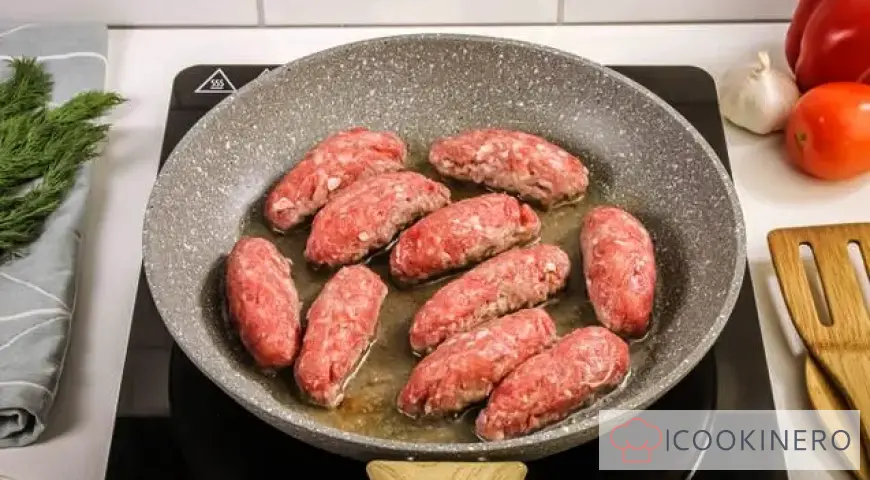 Chevapchichi in bell pepper and tomato sauce