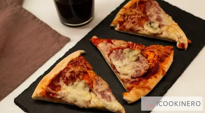 Pizza with mushrooms, salami, parmesan and mozzarella cheeses