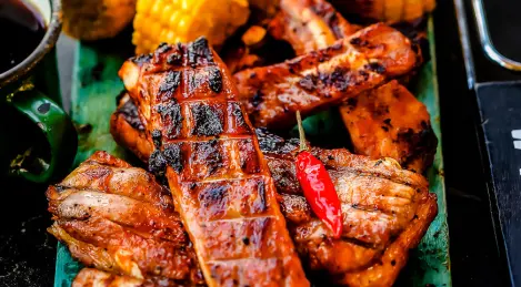 Ribs in barbecue sauce with grilled corn