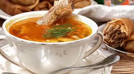 Shchi on pork ribs with sauerkraut and pancakes with meat for a snack