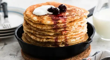 Openwork pancakes in milk with yeast