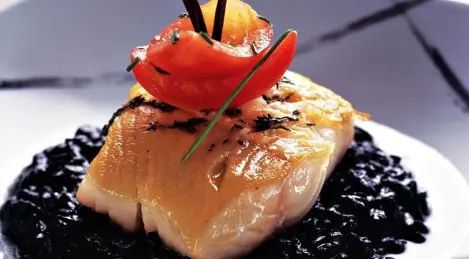 Black cod with black risotto and sweet tomatoes
