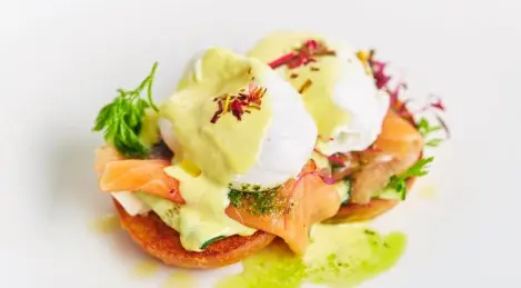 Poached egg with red fish and beurre blanc sauce