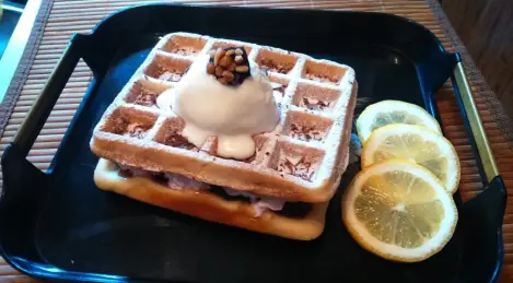 Viennese waffles with strawberry jam, whipped cream and sundae