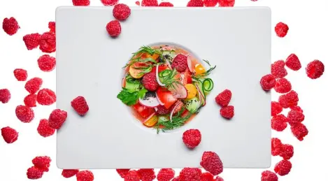 Vegetable salad with raspberries and physalis dressed with light gazpacho