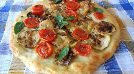 Potato pizza with tomatoes and zucchini