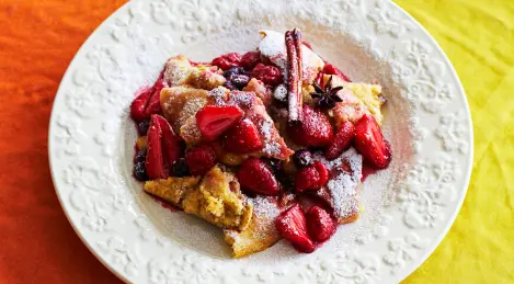 Soufflé omelet in a pan with berry sauce