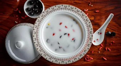 Coconut soup with olives, corn and barberry