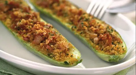 Zucchini with tomatoes, cheese and breadcrumbs baked in the oven