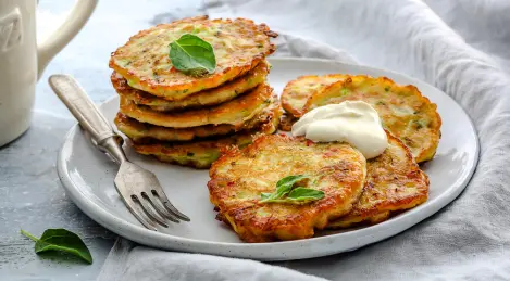 Lush pancakes from zucchini with basil