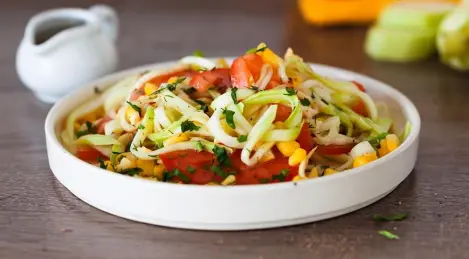 Zucchini salad with tomatoes, garlic and corn