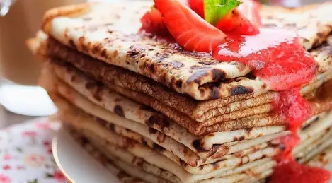 Delicate pancakes on kefir with strawberry sauce