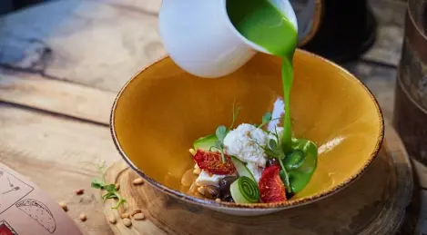 Cold green pea soup with homemade cheese