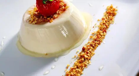 Baked milk jelly with honey and nuts in caramel