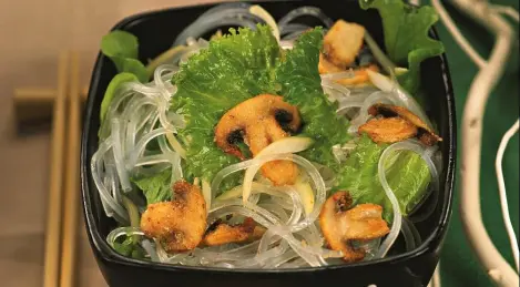 Mushrooms in breadcrumbs with rice noodles and Frize salad