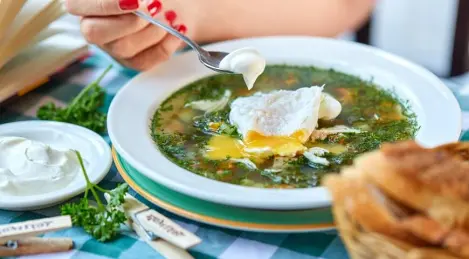 Green cabbage soup with poached egg