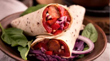 Hot dogs with red onion in a tortilla, as they are prepared in Arizona