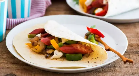Sausages with fried peppers in a tortilla