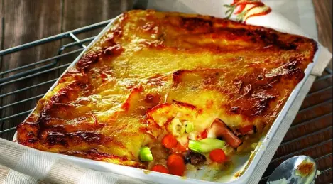 Potato casserole with turkey meat and cranberry sauce