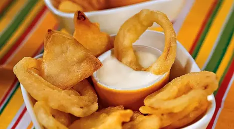 Onions and celery in batter with cheese sauce