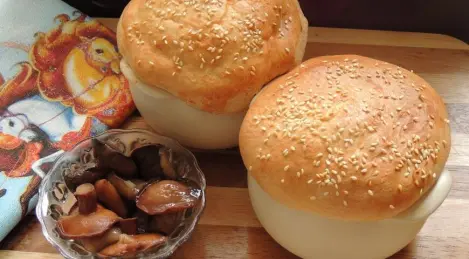 Pork in pots with marinated butter and dough lids