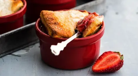 Dessert of strawberries and rhubarb under a cap of tender dough