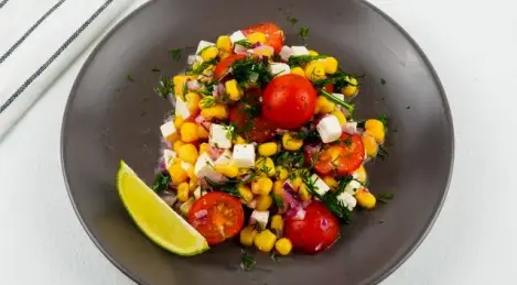 Salad with corn, cherry tomatoes and feta cheese