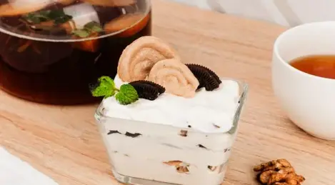Creamy dessert with meringue, Oreo and nuts