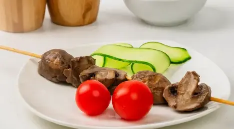 Champignons on skewers in mayonnaise marinade
