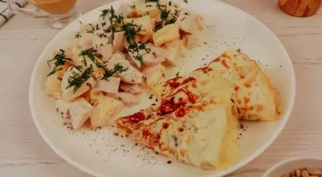 Salad with egg pancakes, chicken and pineapple