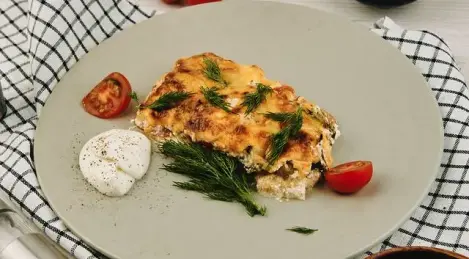 Baked pollock under a cheese and sour cream cap