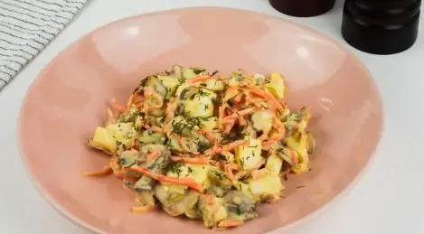 Salad of champignons, Korean carrots, eggs, gherkins with mayonnaise